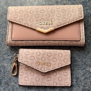 Beautiful guess wallet, set new without tags never carried light, pink and color